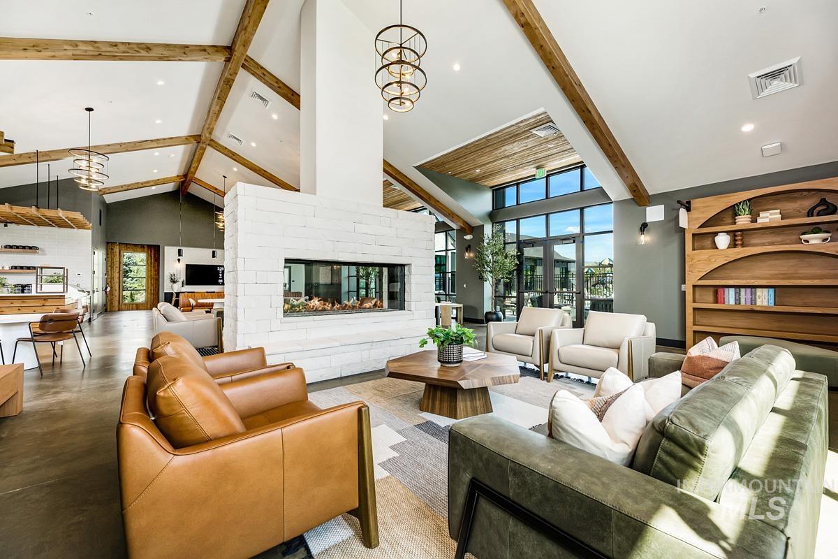 Community lobby with beamed ceiling, high vaulted ceiling, and recessed lighting