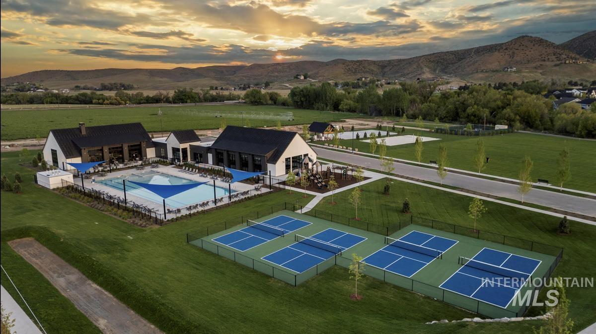 Overview of rural landscape featuring a pool area and a mountain backdrop
