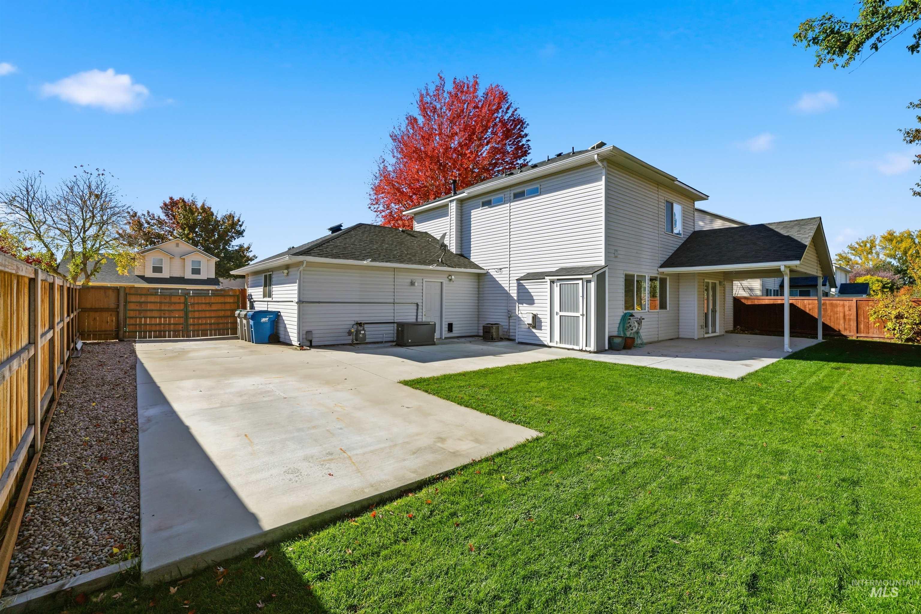 Back of house featuring a fenced backyard, a patio, and a gate