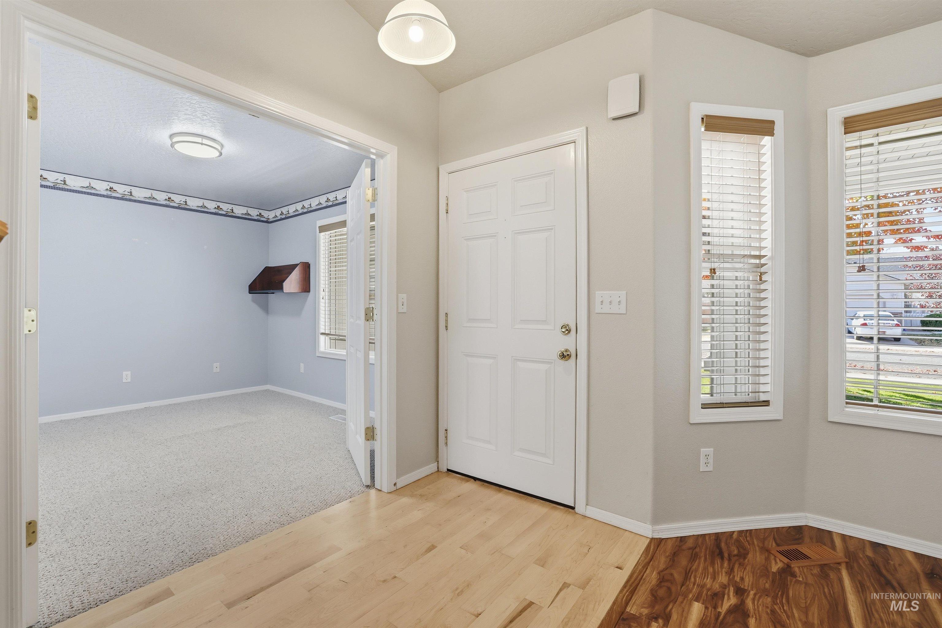 Entryway with wood finished floors and healthy amount of natural light