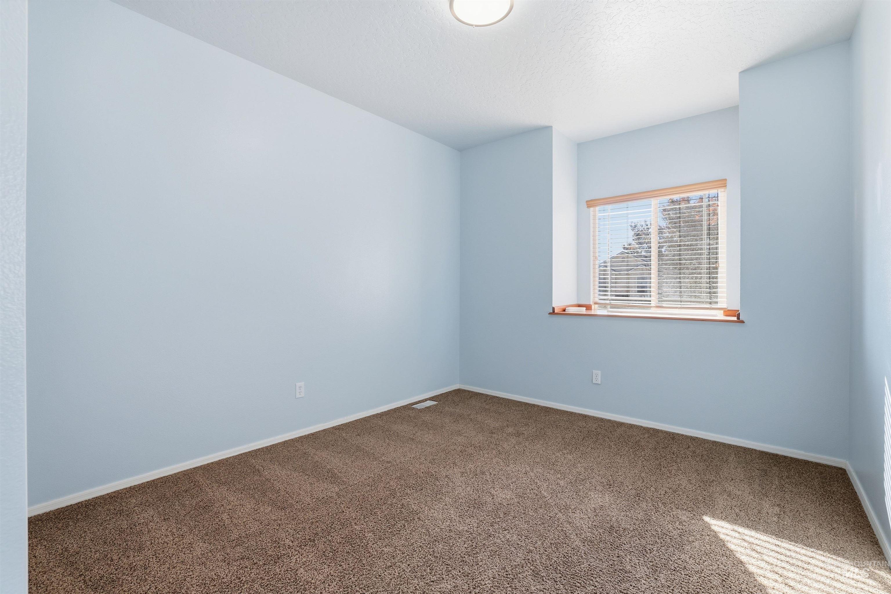 Unfurnished room featuring carpet flooring and baseboards