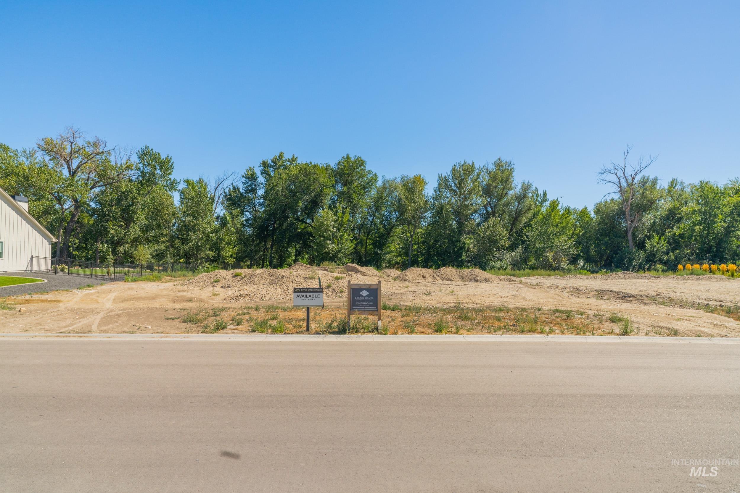 View of asphalt road with view of scattered trees