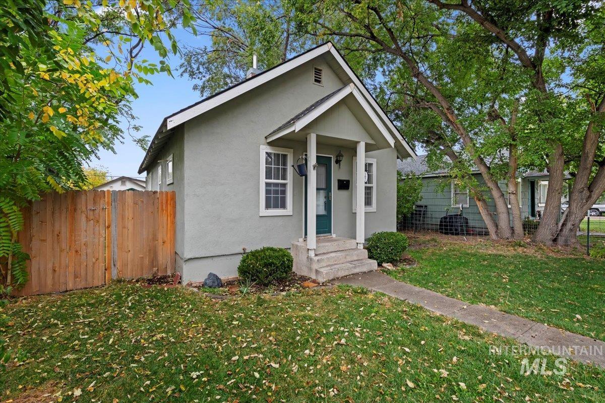 Bungalow-style home with stucco siding