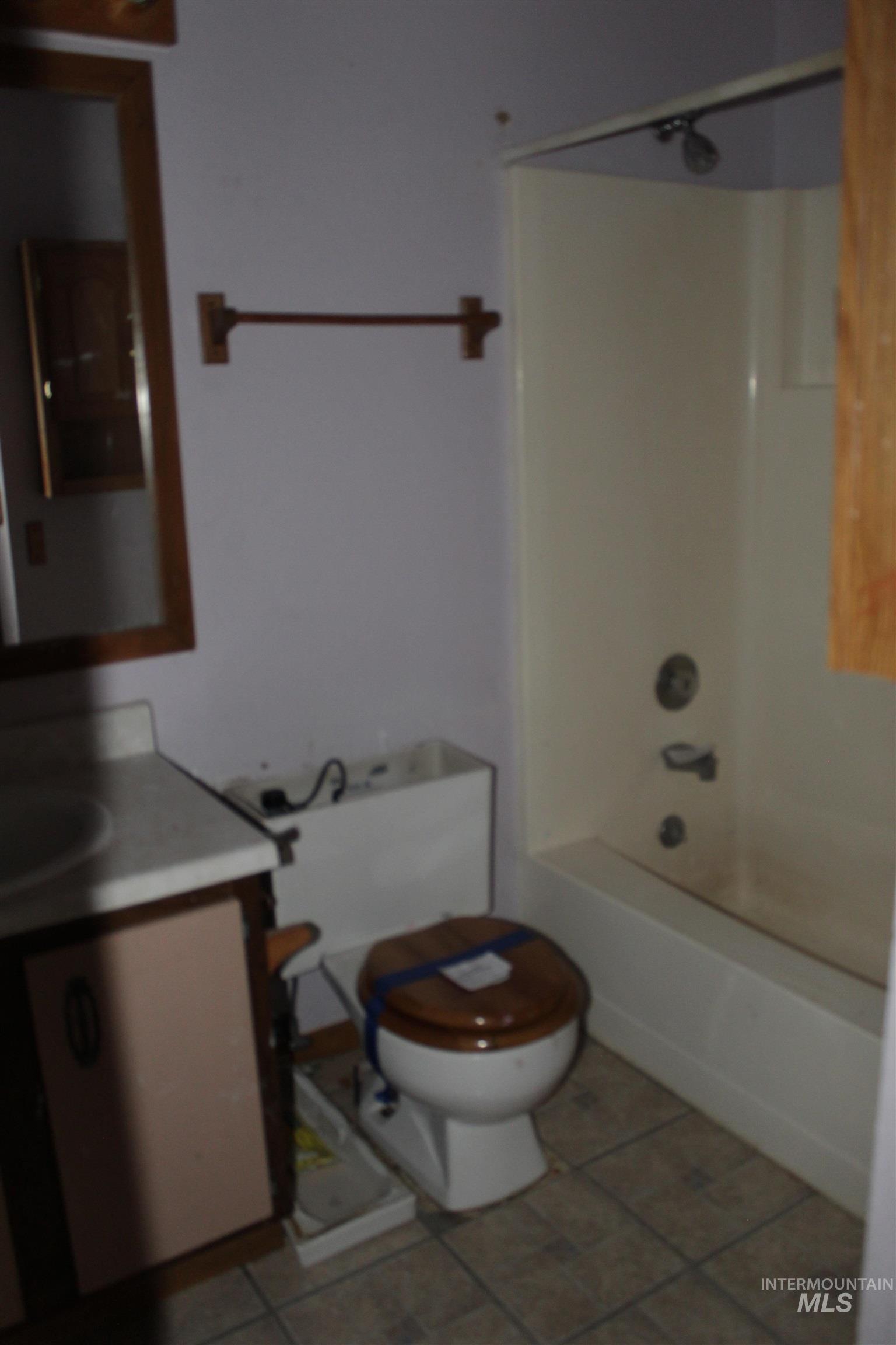 Full bath with vanity,  shower combination, and light tile patterned floors