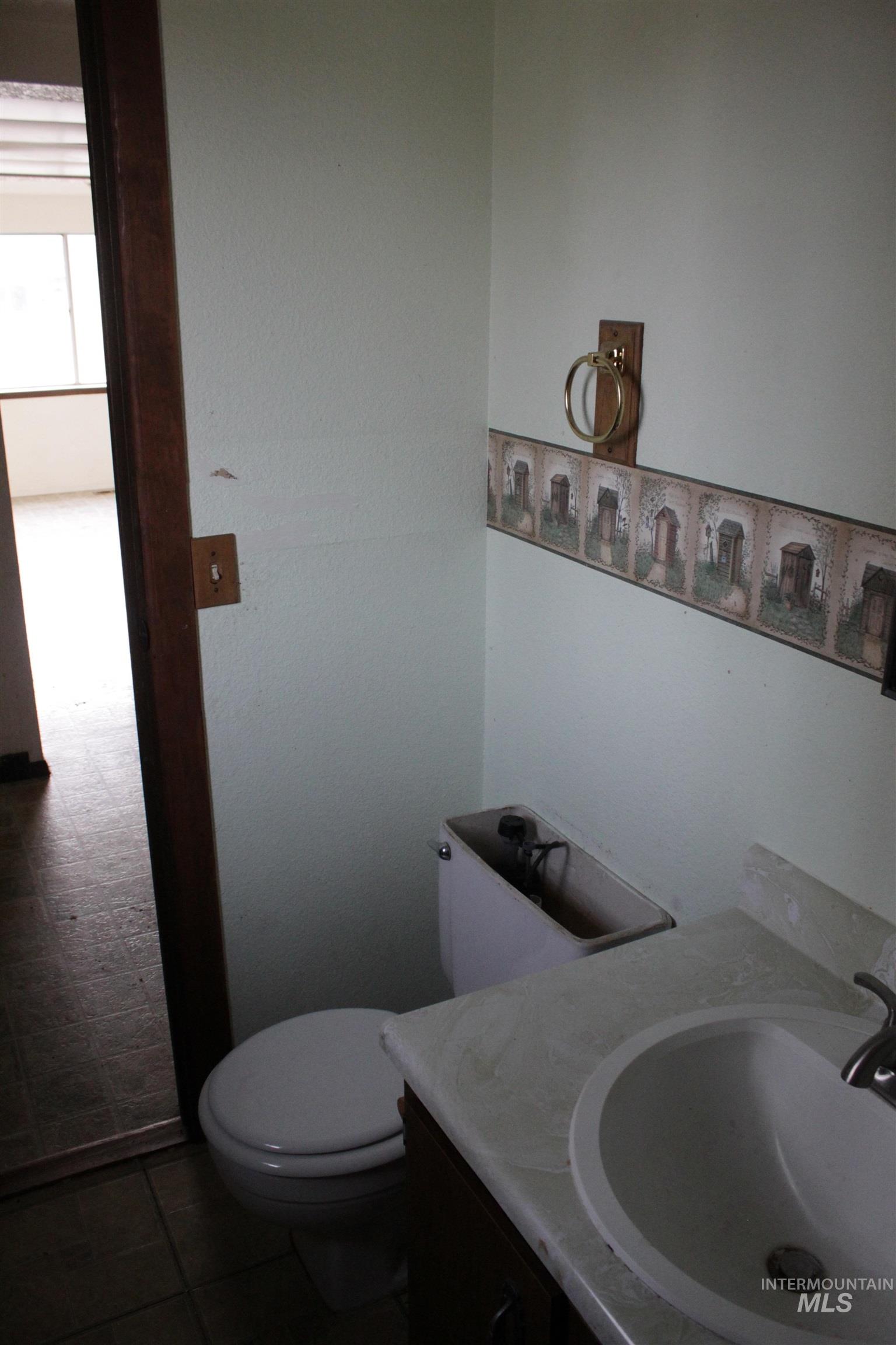 Bathroom with vanity and dark tile patterned floors