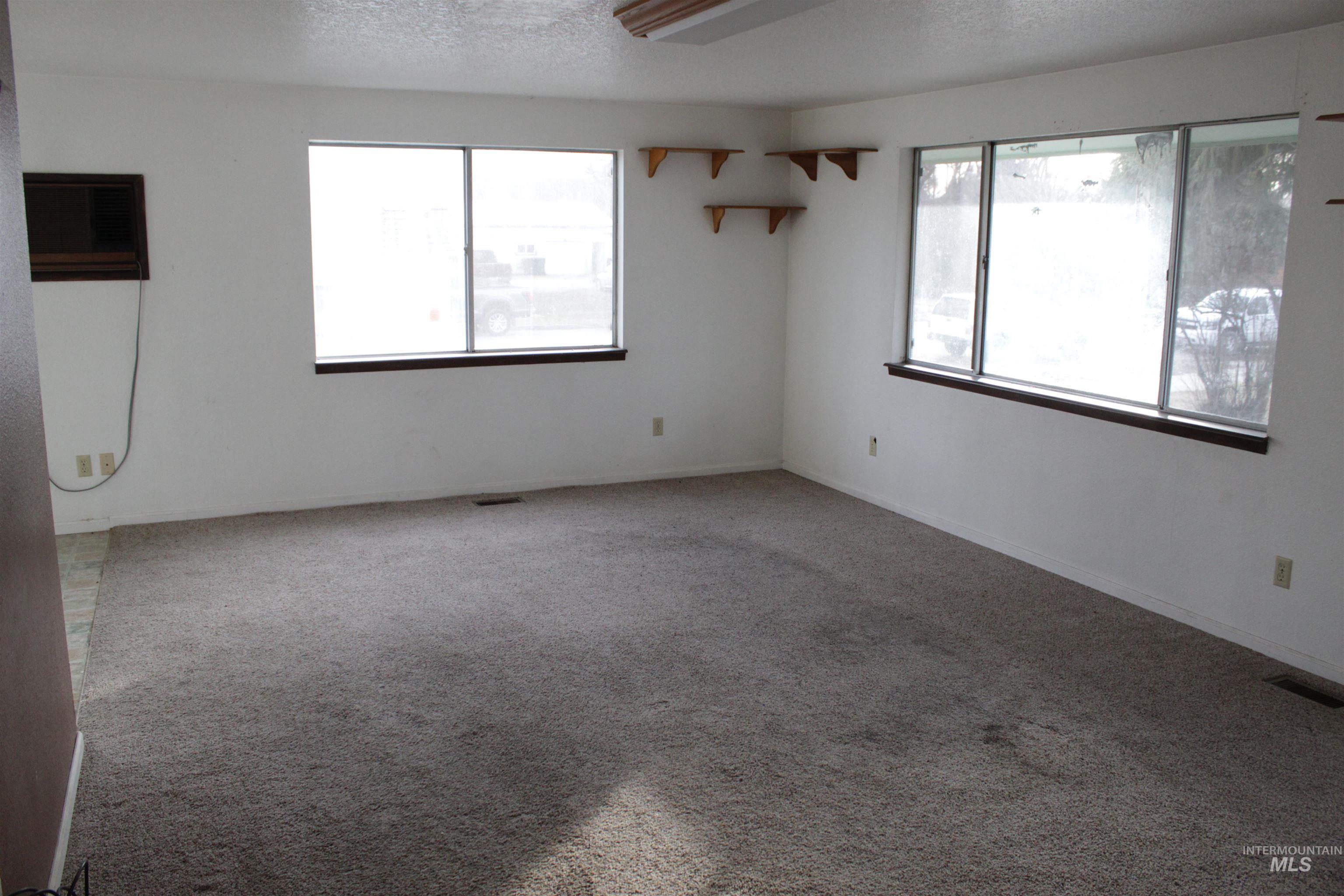 Carpeted spare room with a textured ceiling