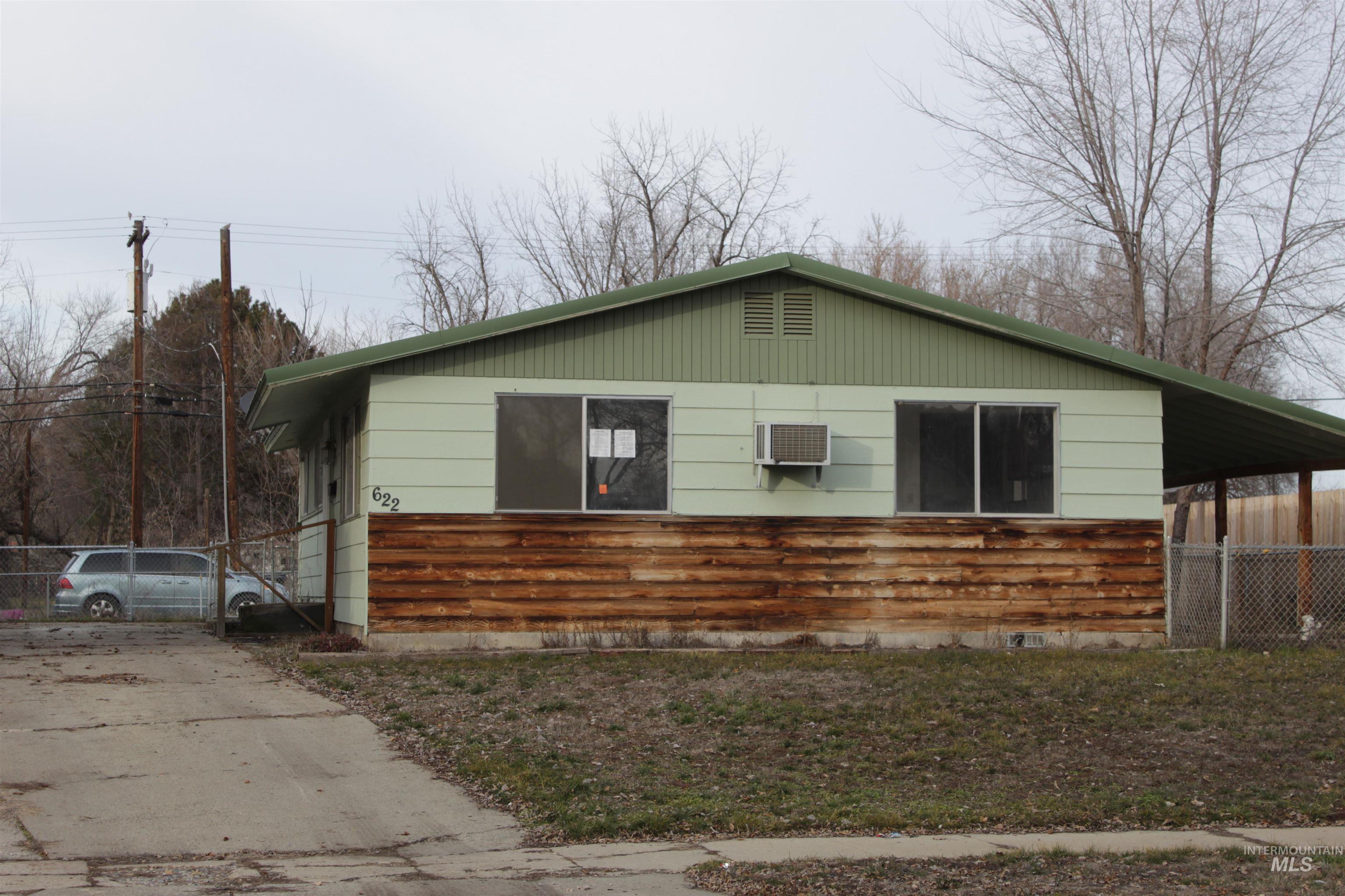 View of side of home with an AC wall unit