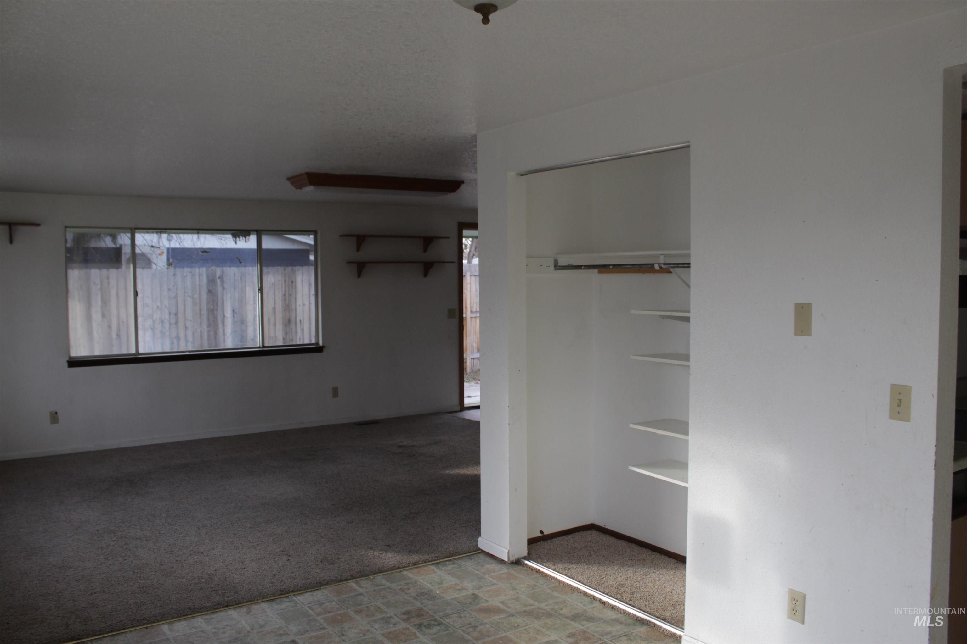 Unfurnished bedroom featuring a closet and light carpet