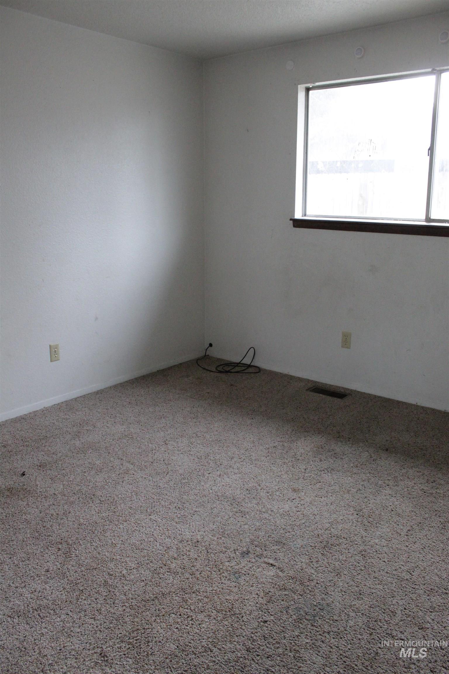 Empty room with carpet flooring