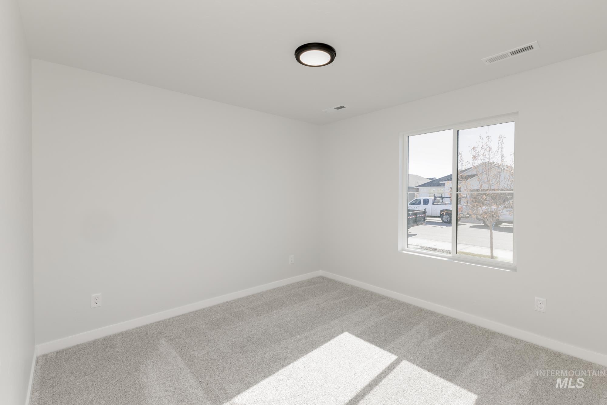 Unfurnished room with carpet flooring and baseboards