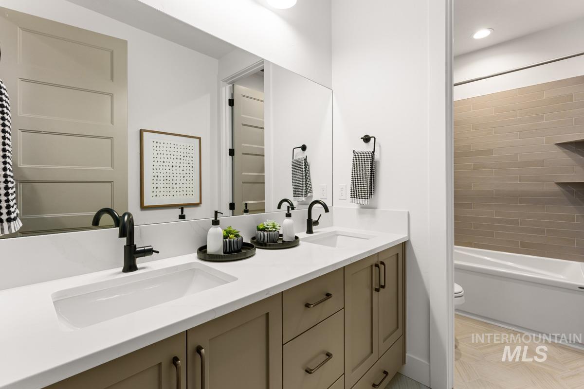 Double vanity with white solid surface countertop and undermount sinks