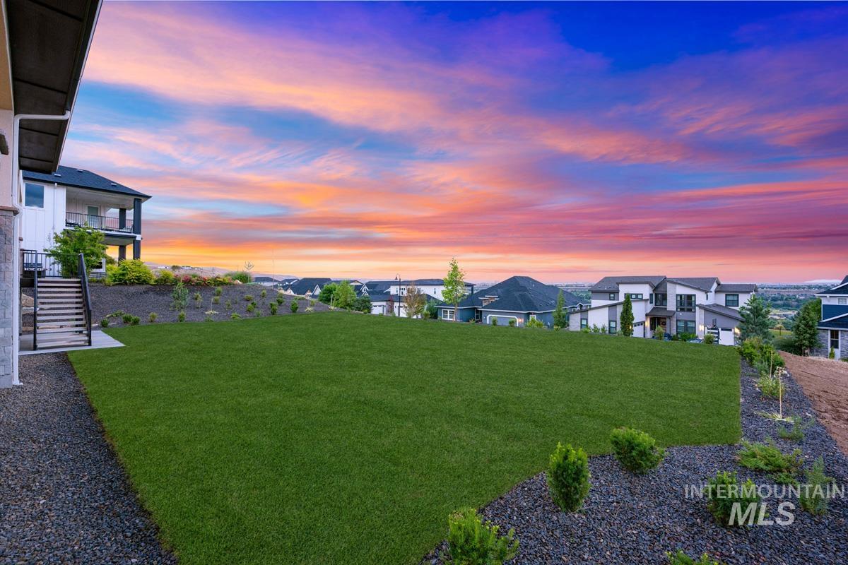 Expansive level lawn with surrounding dark gravel landscaping