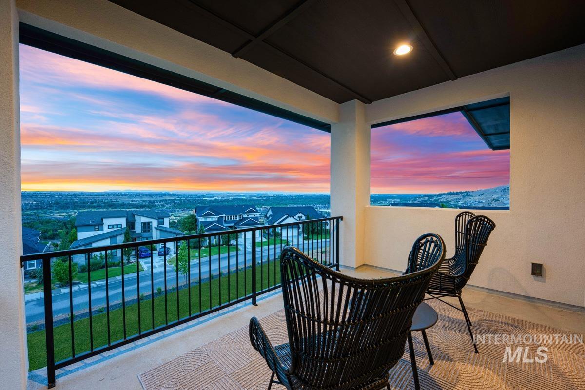 Covered balcony featuring a black metal railing and overhead recessed lighting