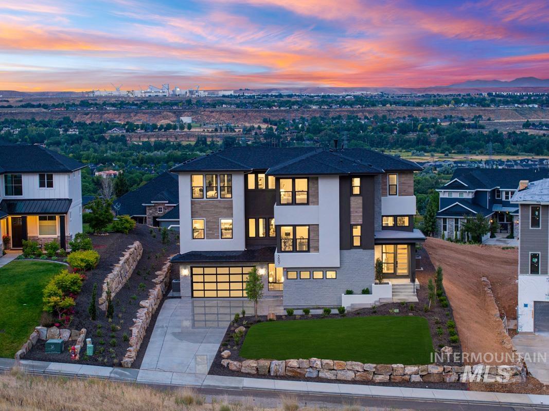 Contemporary multi-level residence featuring a composite shingle roof and a two-car garage with a glass-paneled door