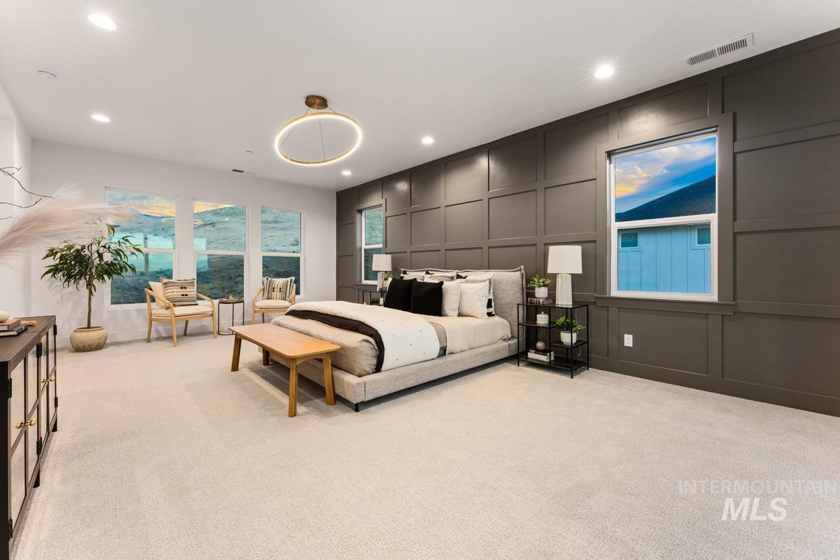 Spacious interior featuring neutral carpeting and a dark accent wall with panel molding