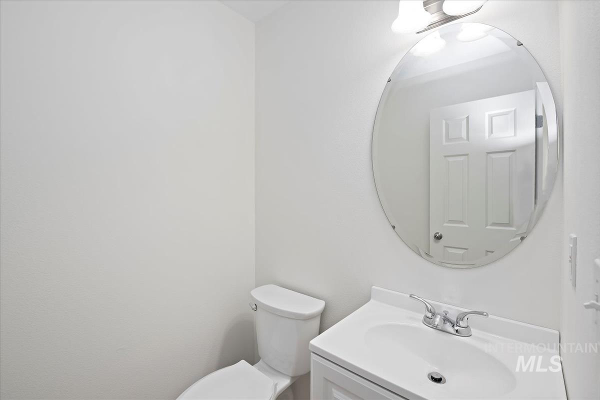 Powder bathroom with vanity and toilet