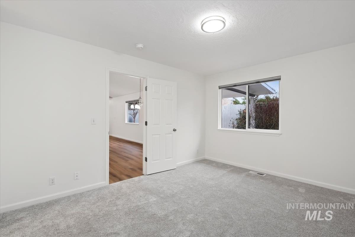 Unfurnished room with baseboards and carpet floors