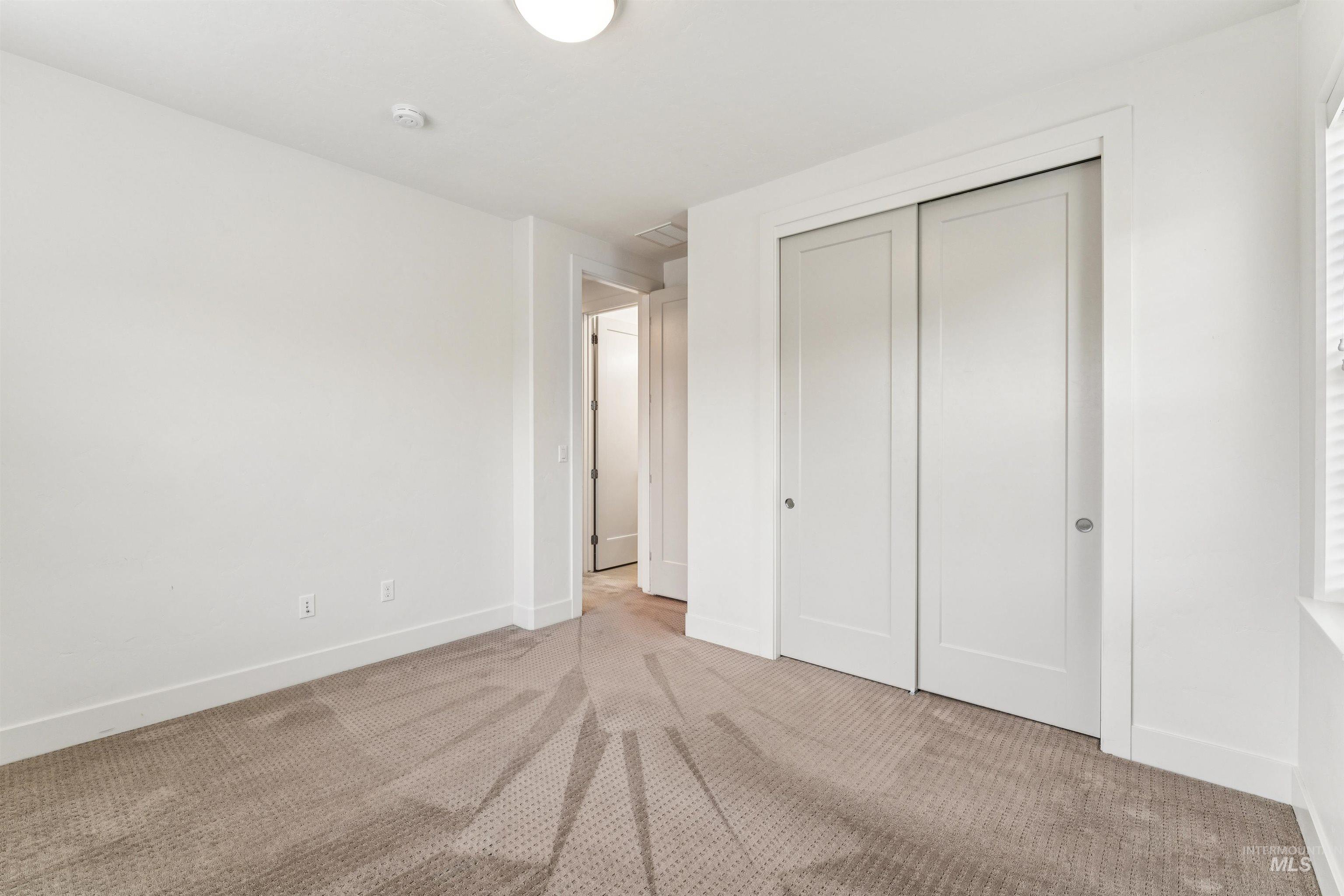 Bedroom featuring carpet floors and a closet