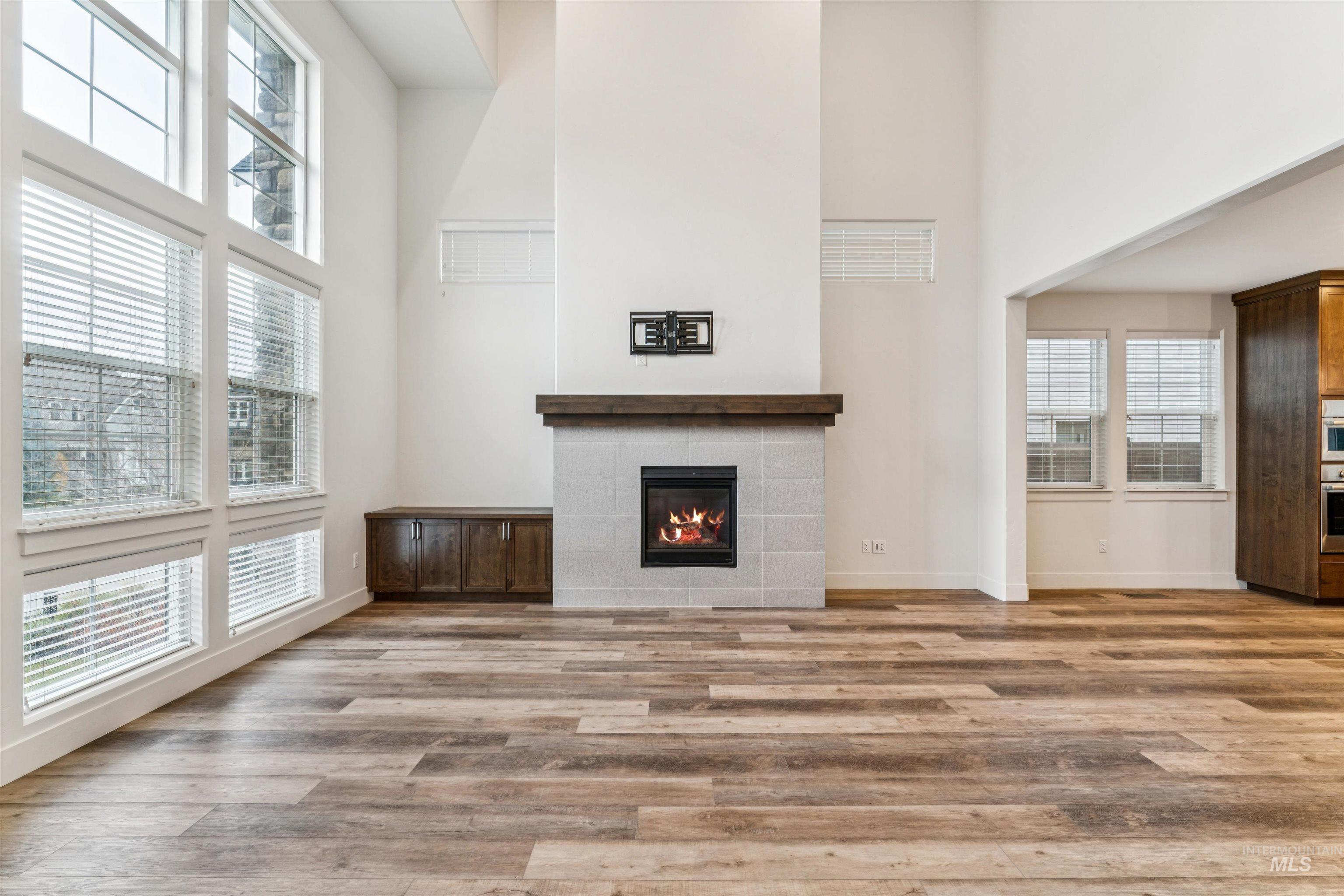 Living room featuring a fireplace and a towering ceiling