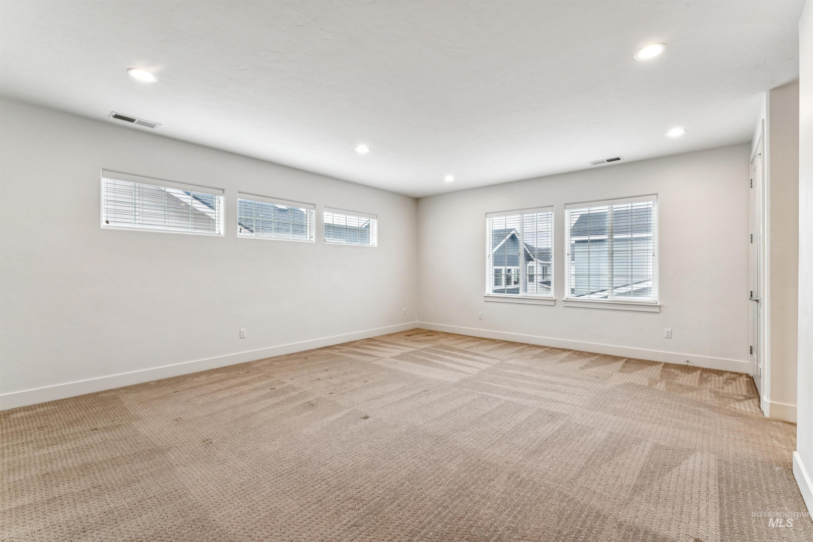 Bonus room featuring healthy amount of natural light, recessed lighting and closet for optional 4th bedroom - easily add a barn door.