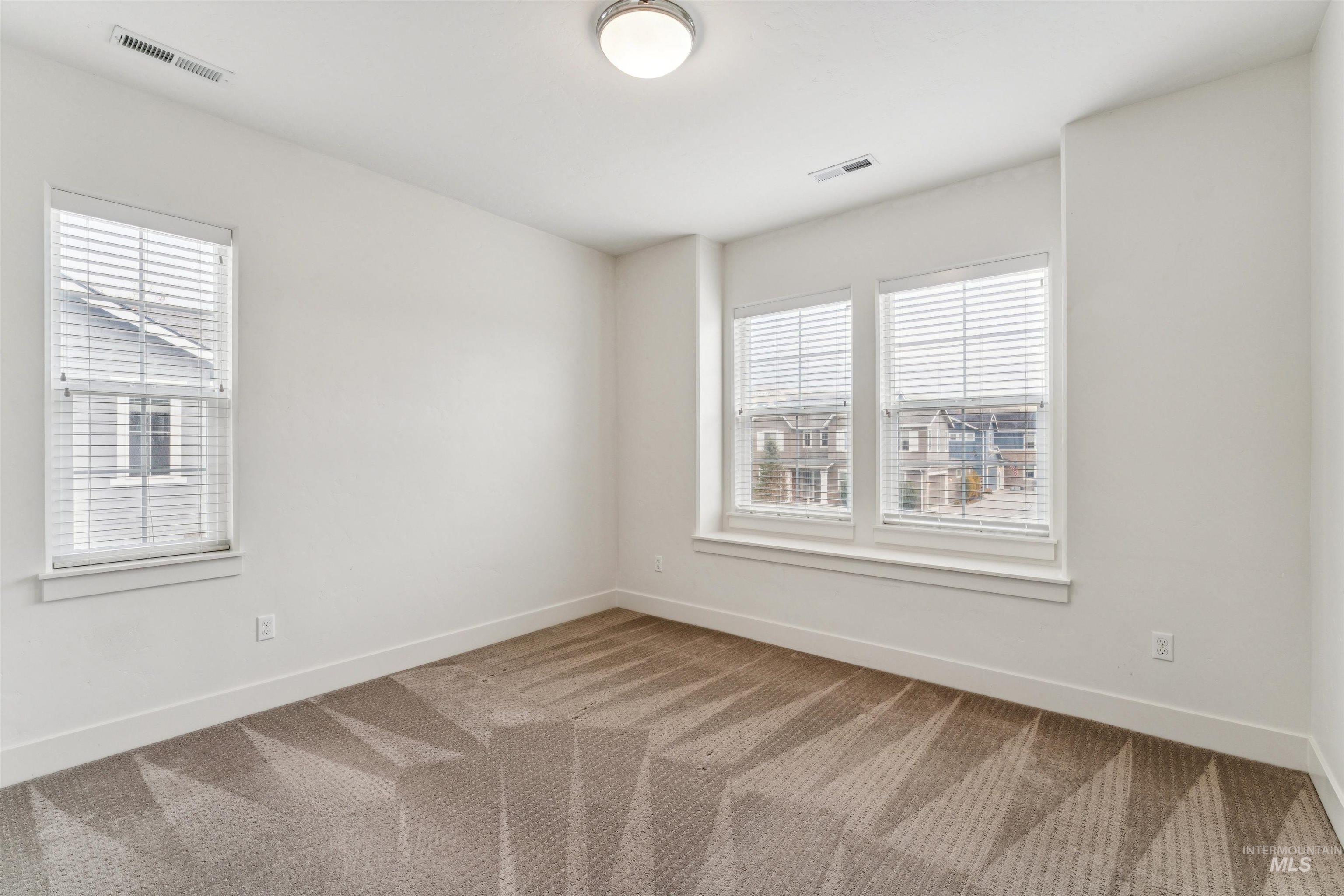 Bedroom featuring carpet and healthy amount of natural light