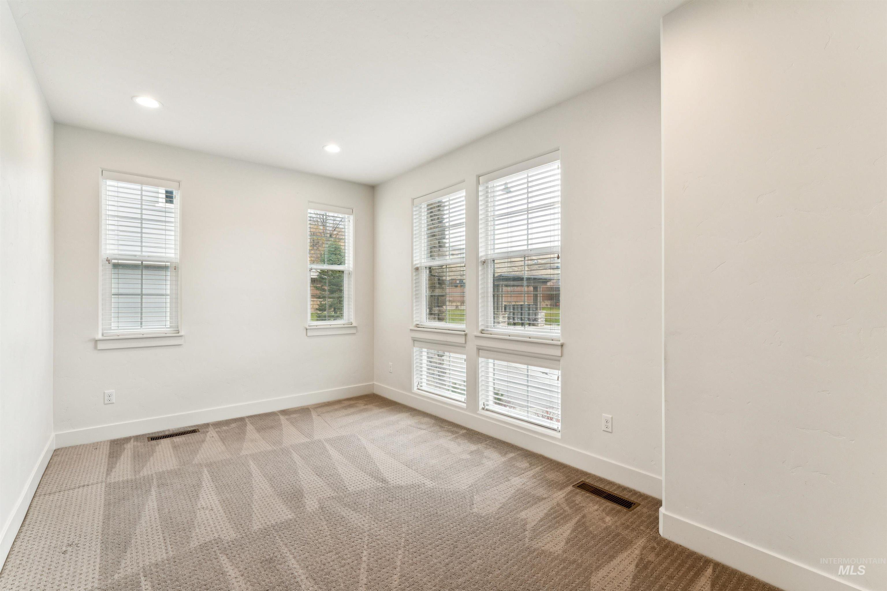 Office featuring carpet flooring and recessed lighting with lots of natural light