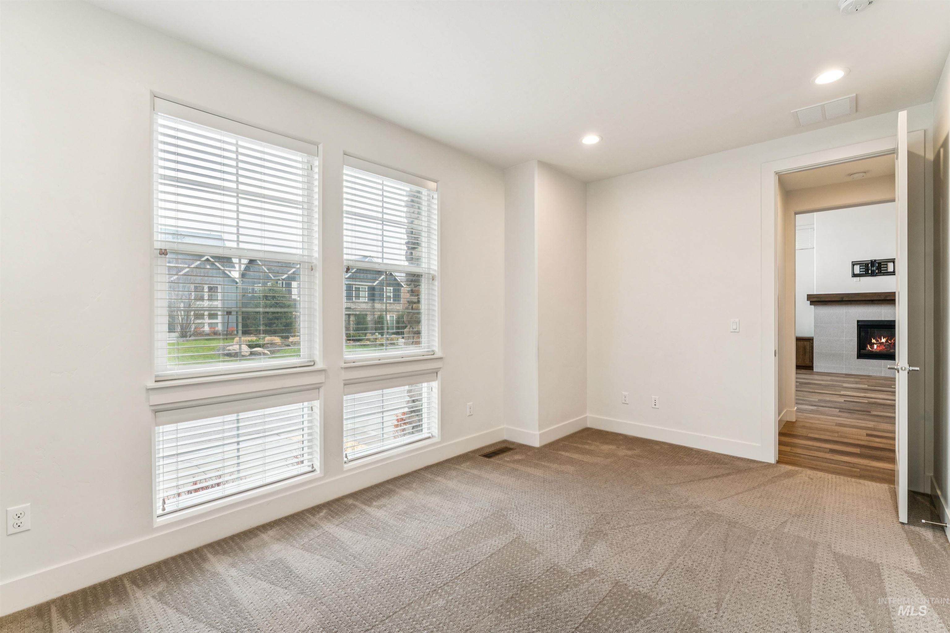 Office featuring recessed lighting, light carpet and lots of natural light.