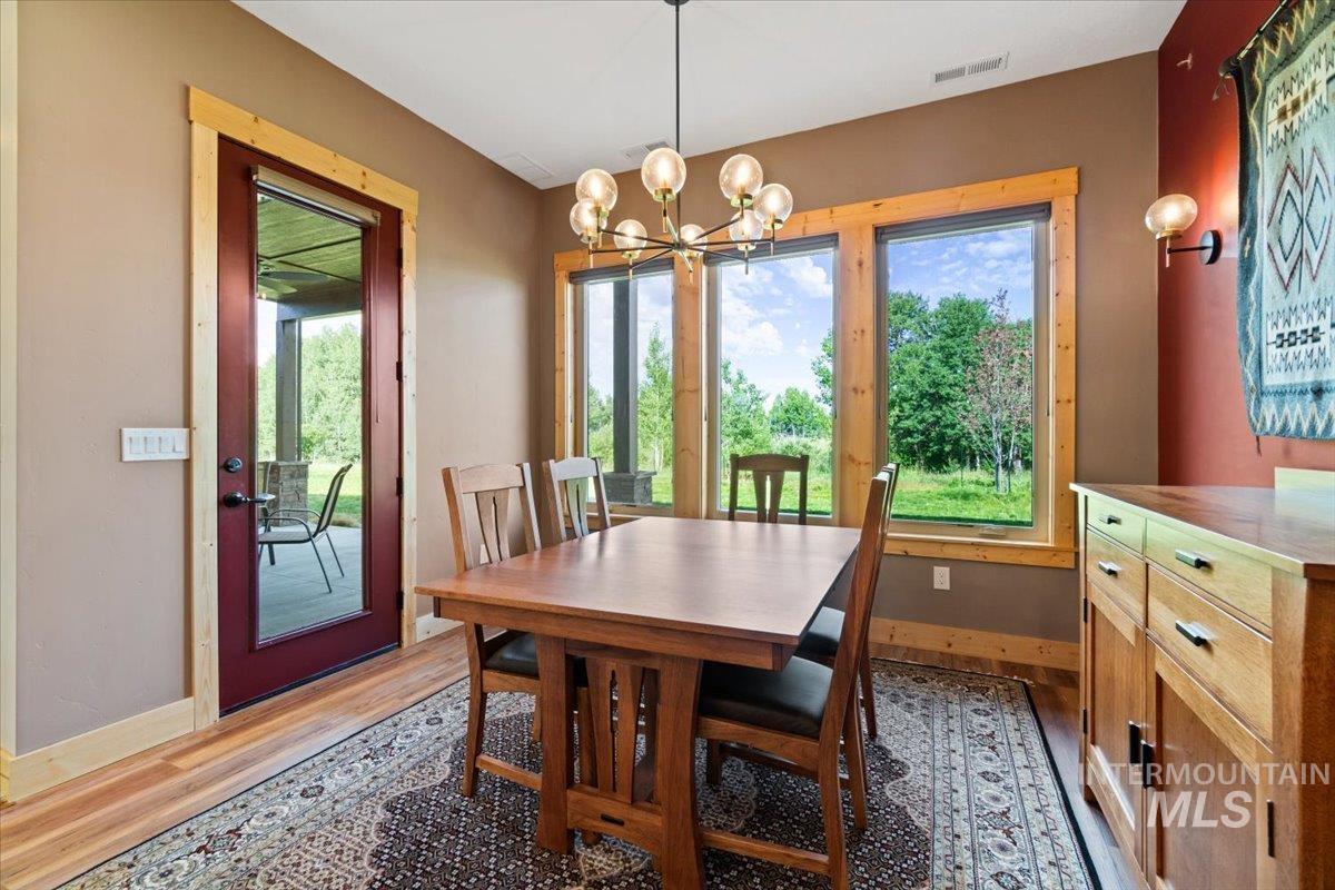 Dining space with light wood-style flooring and a chandelier