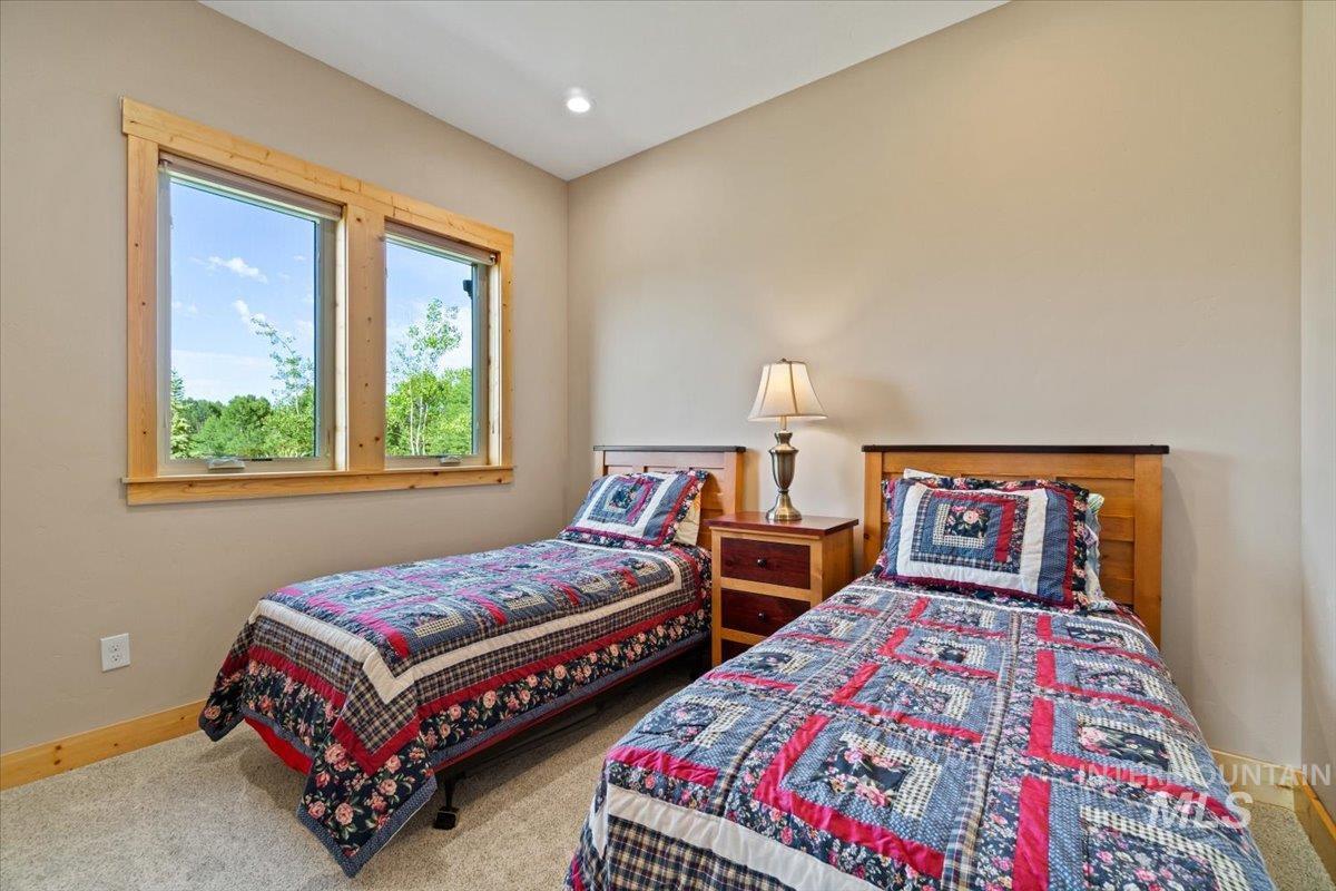 Carpeted bedroom with baseboards and recessed lighting