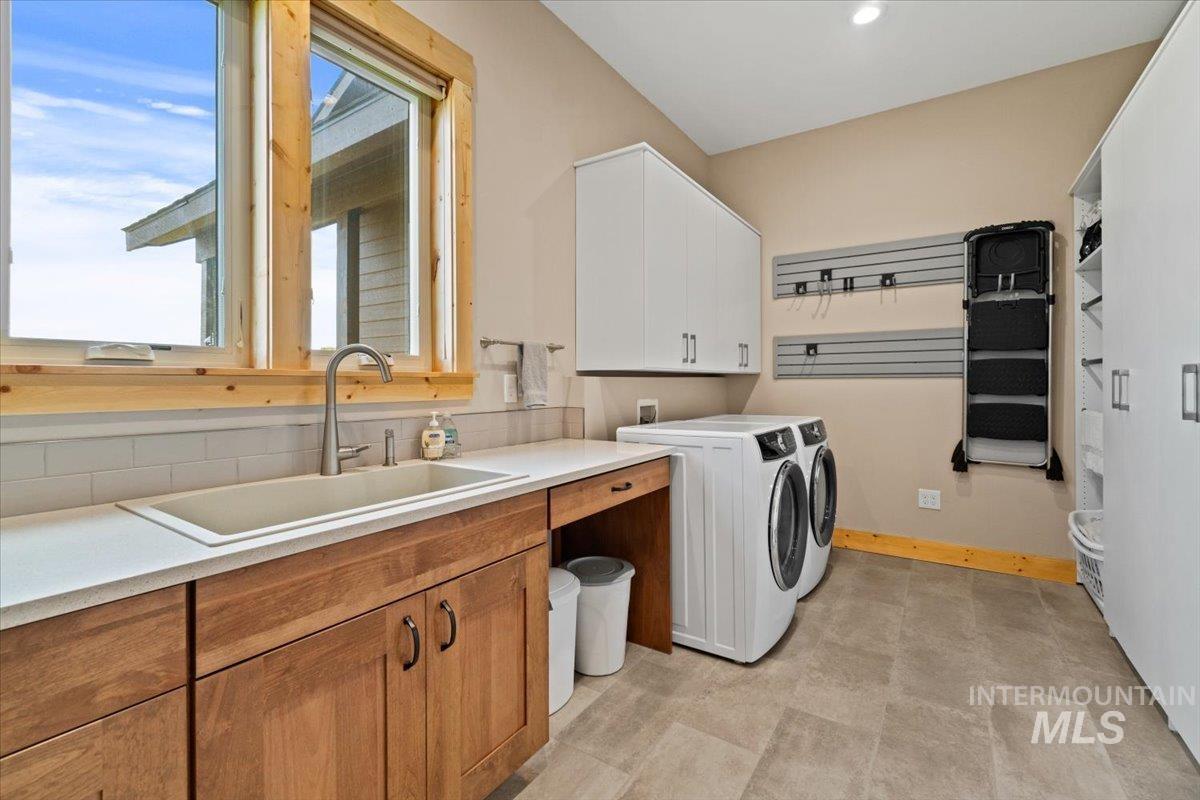 Laundry area featuring cabinet space and washing machine and dryer