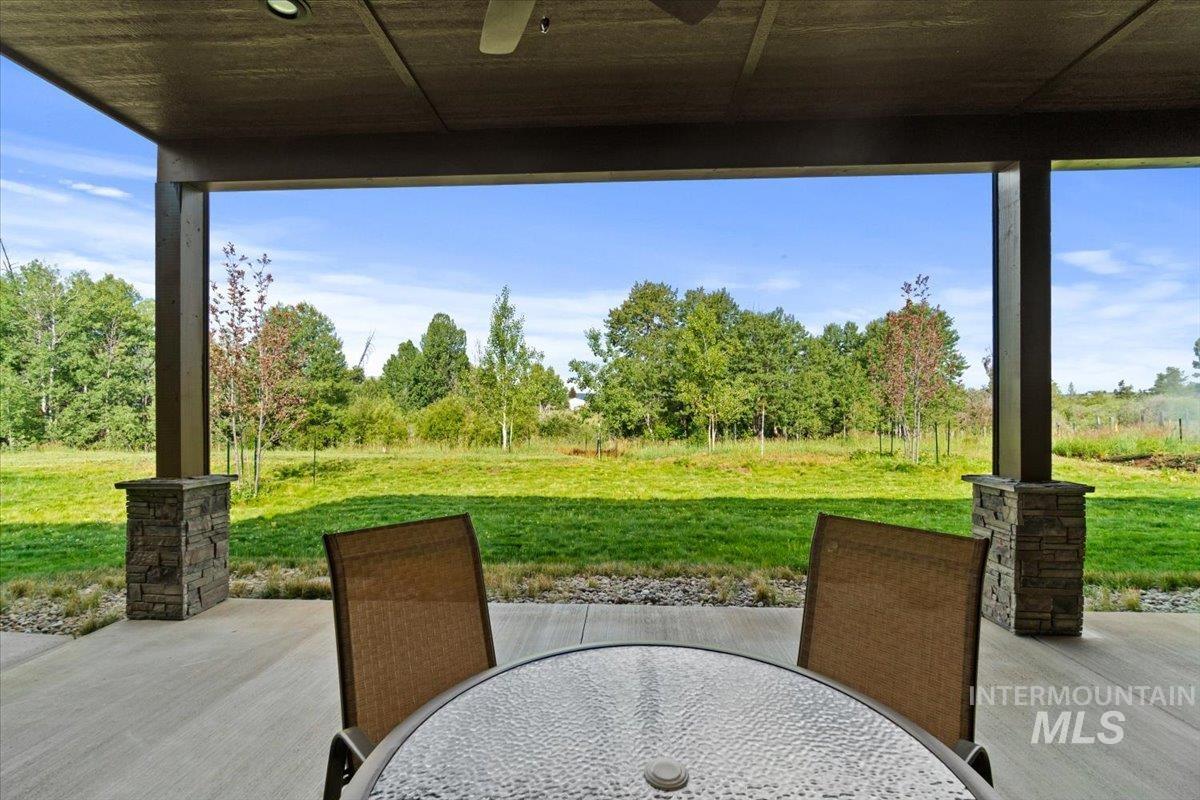 View of patio with ceiling fan and outdoor dining space