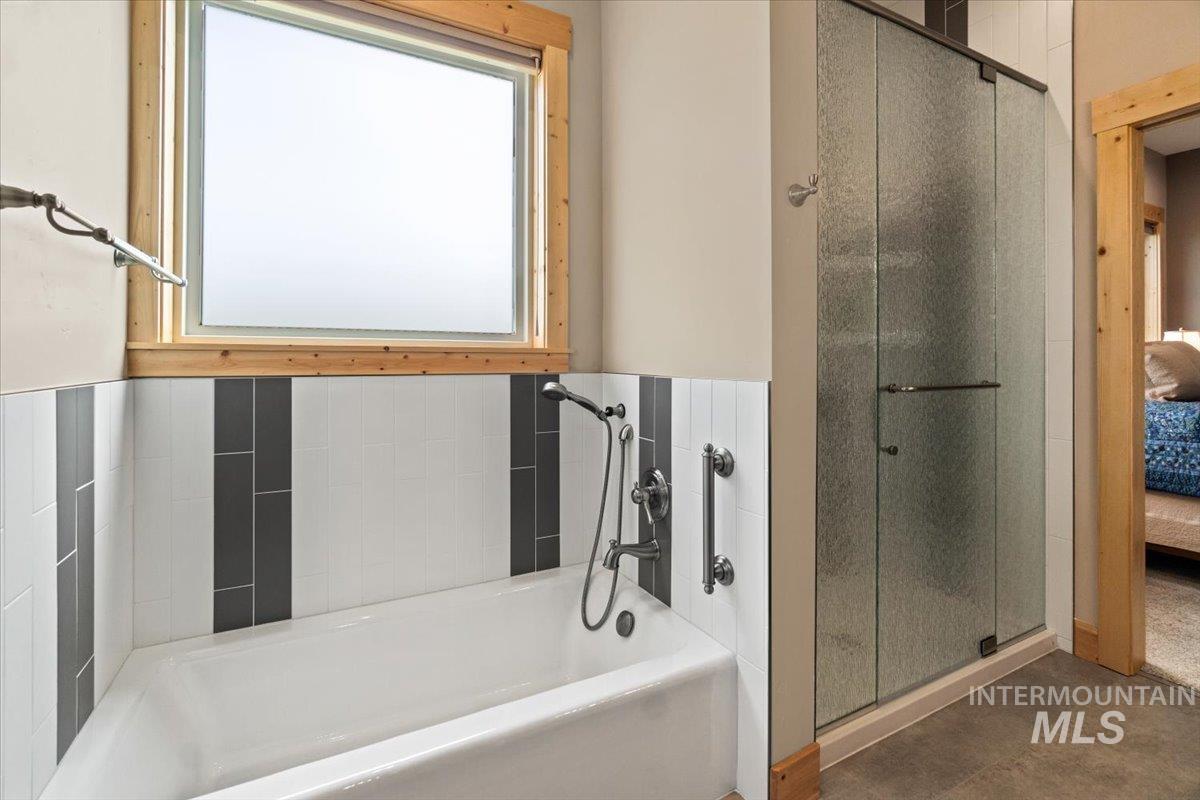 Full bathroom with a bath and a shower stall