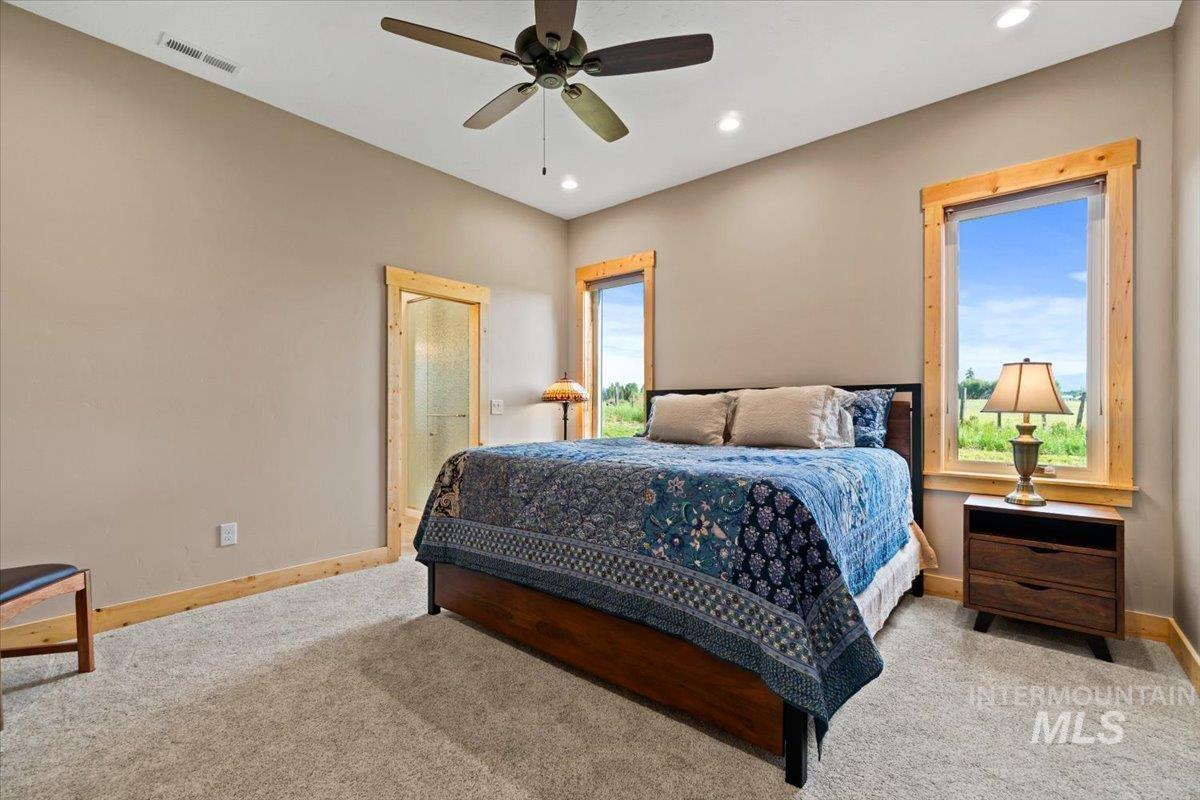 Carpeted bedroom with recessed lighting and ceiling fan