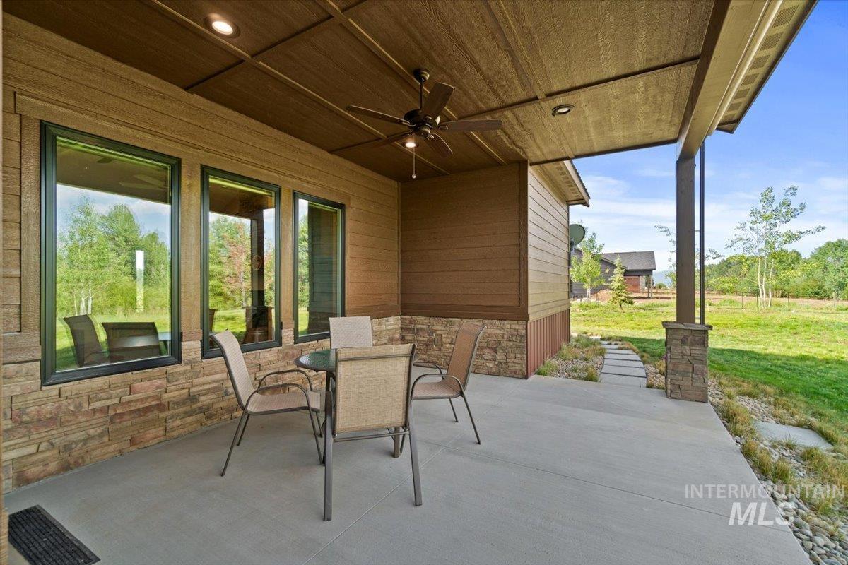 View of patio featuring a ceiling fan and outdoor dining area