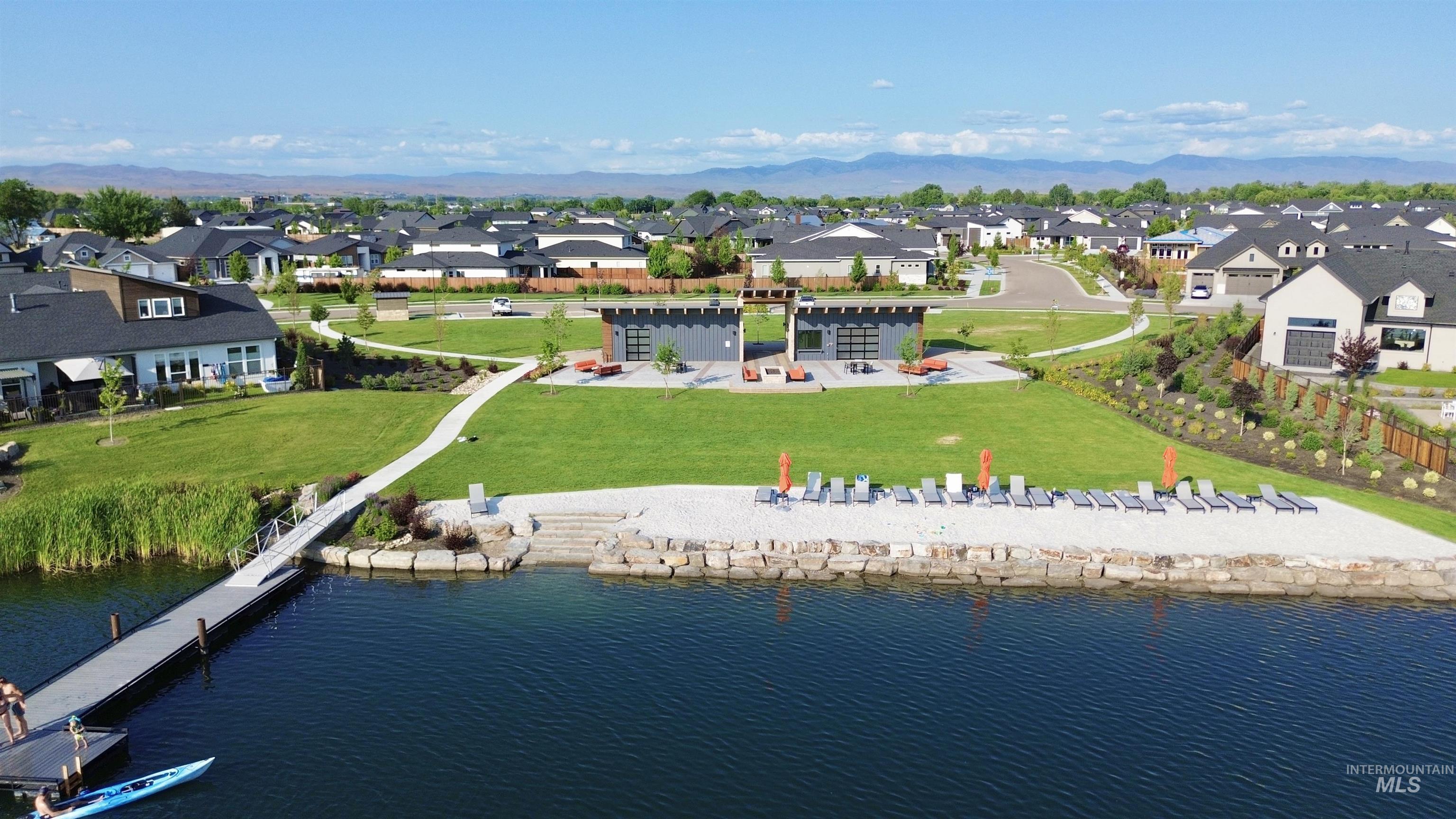 Aerial perspective of suburban area with a water and mountain view