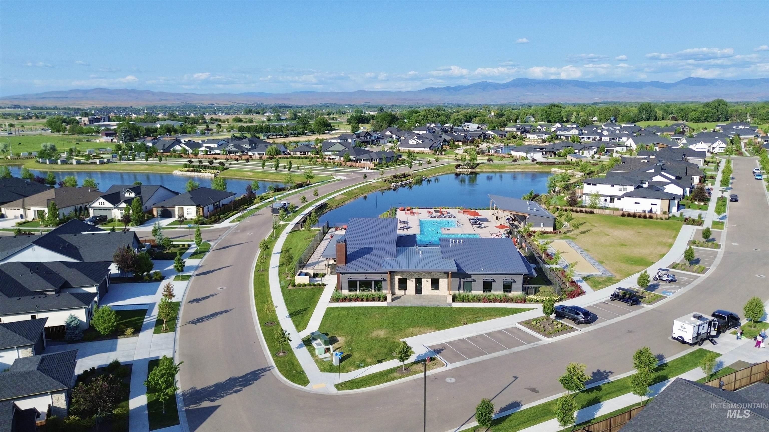 Aerial perspective of suburban area with a water and mountain view