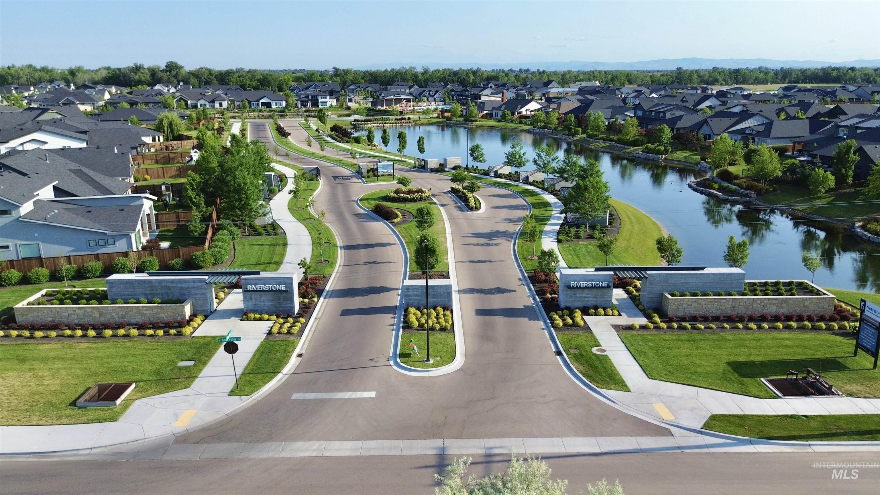 Aerial perspective of suburban area featuring a nearby body of water