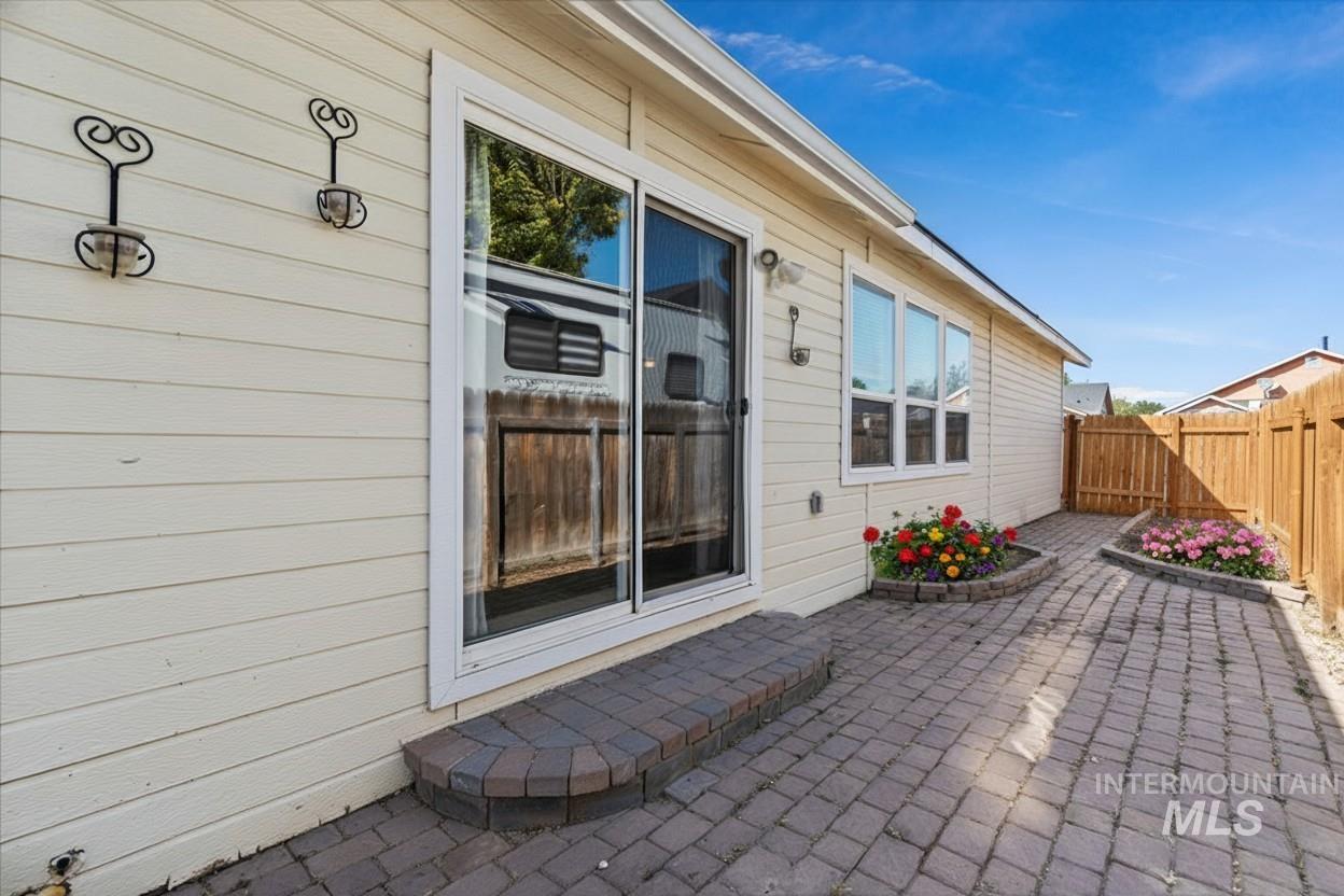 Fenced backyard with a patio (enhanced)