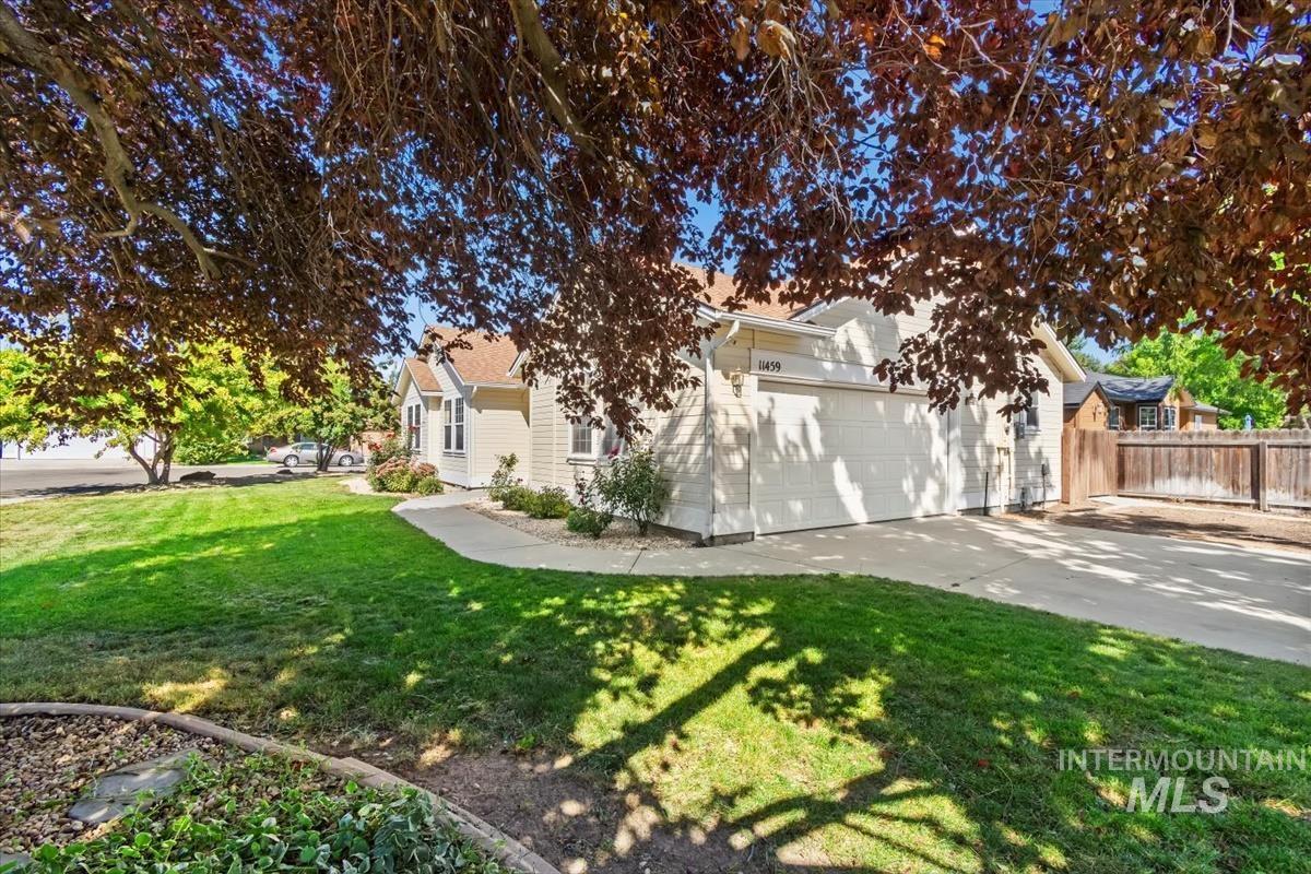 View of side of property featuring driveway and a garage
