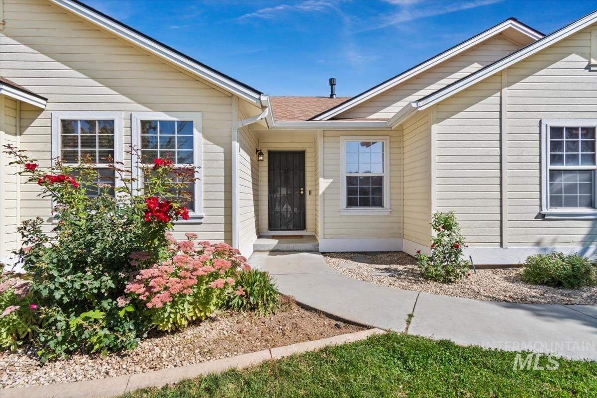 View of exterior entry featuring roof with shingles