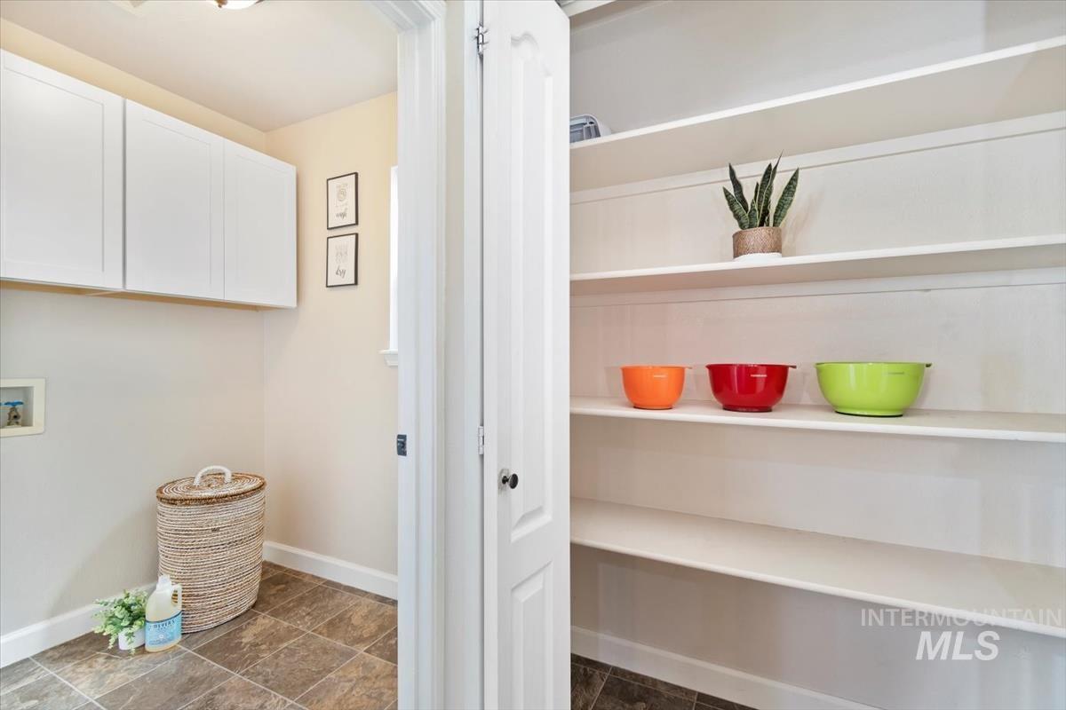 Laundry room featuring hookup for a washing machine and cabinet space