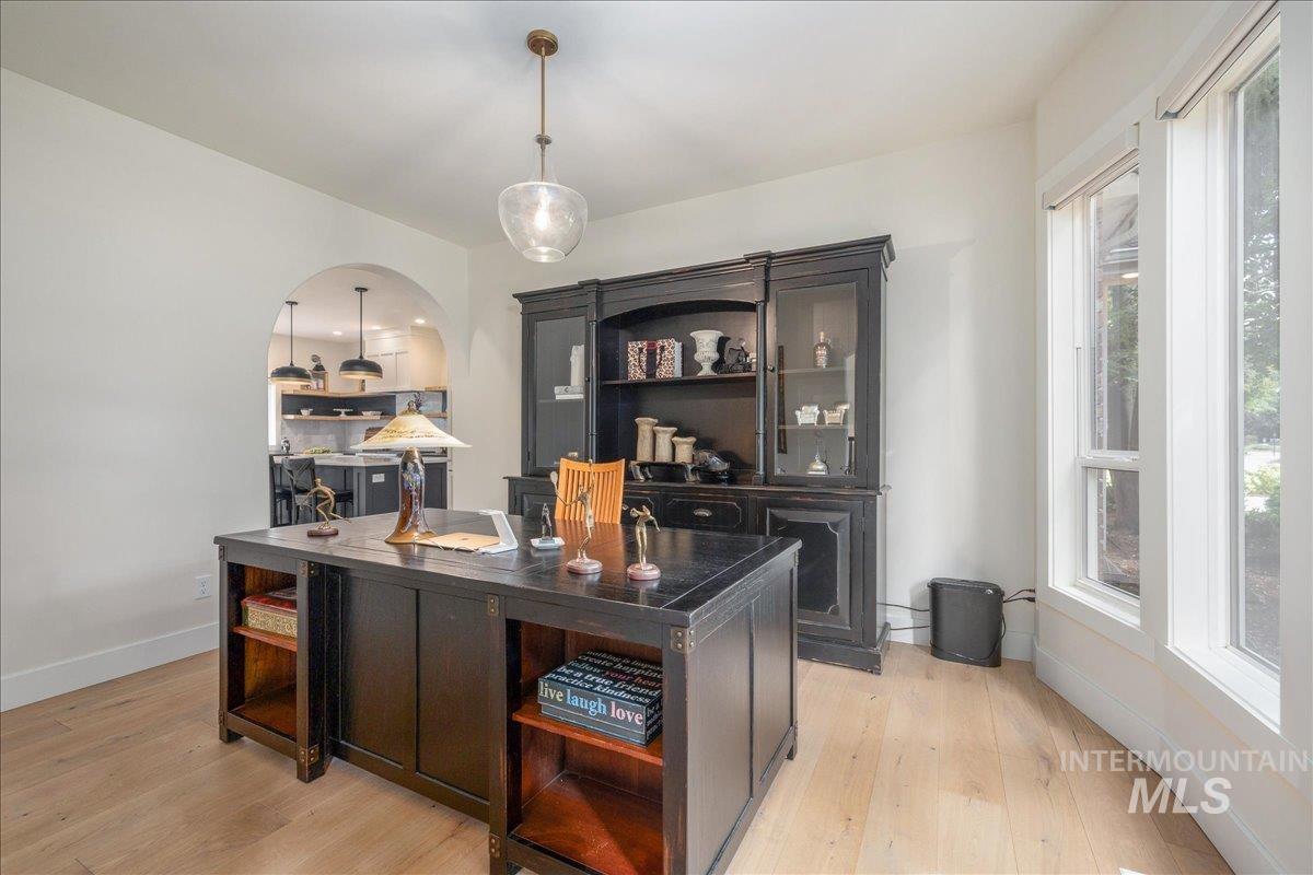 Office area with light wood-style floors and baseboards