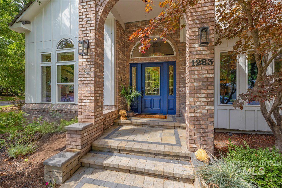 Entrance to property with brick siding and board and batten siding