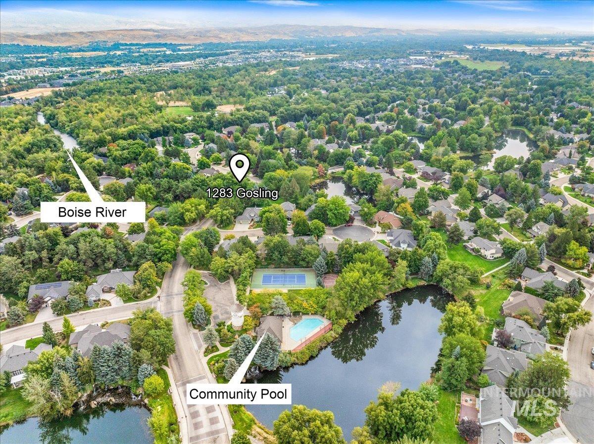 Aerial perspective of suburban area featuring a nearby body of water