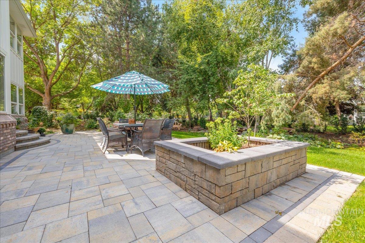 View of patio / terrace featuring outdoor dining space and view of scattered trees