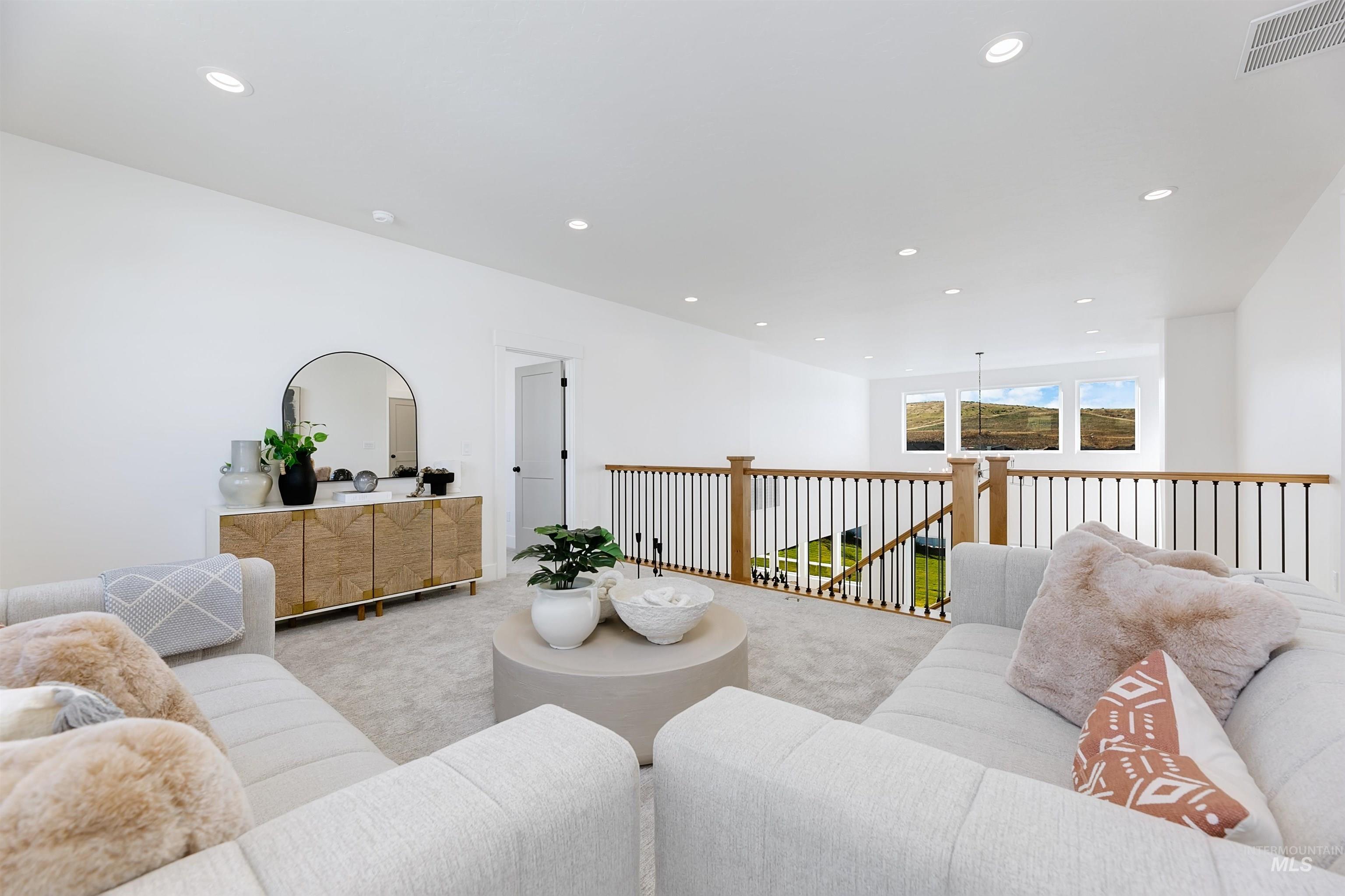 Carpeted living room with recessed lighting
