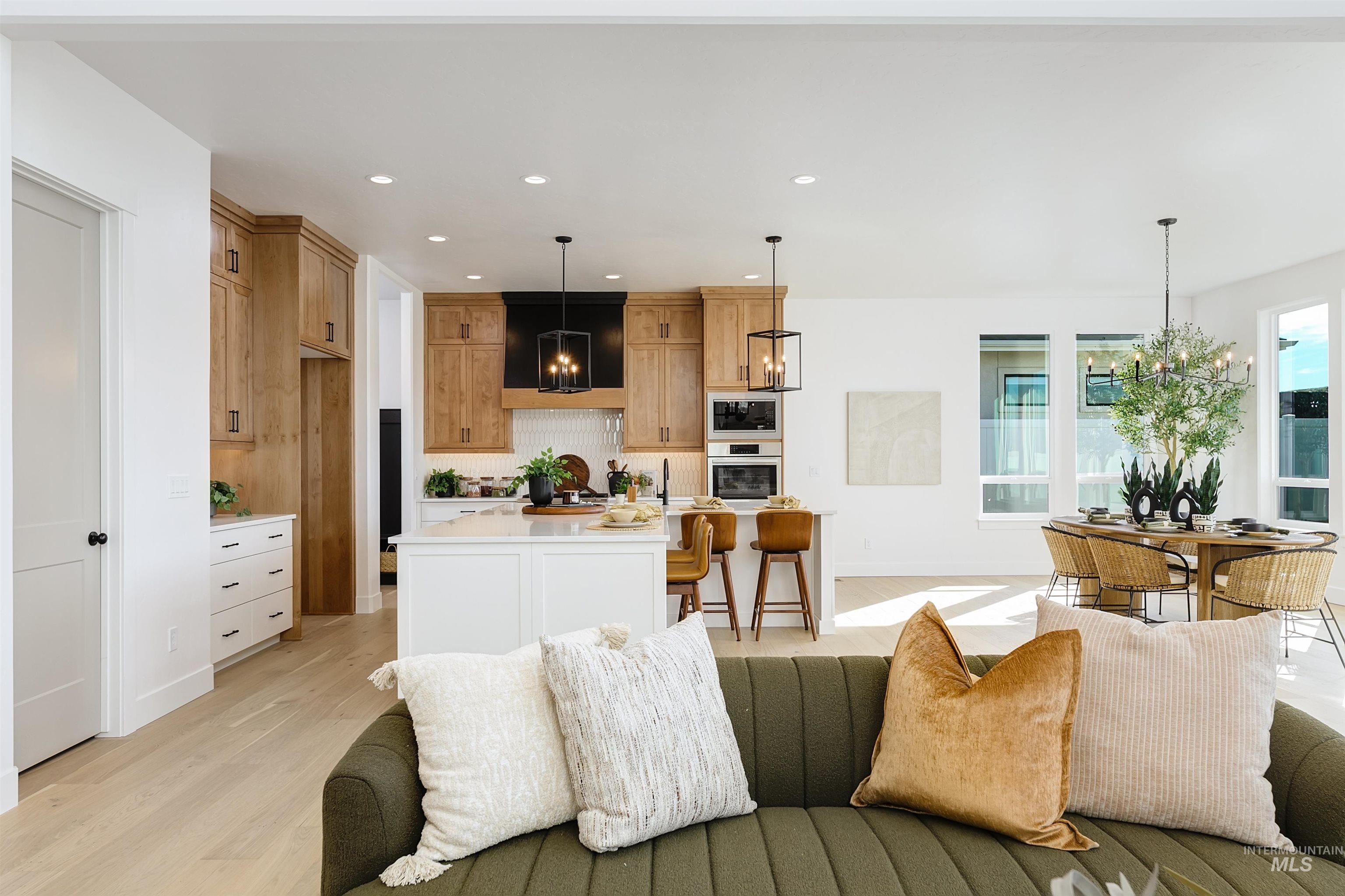 Living room featuring a chandelier, recessed lighting, and light wood-type flooring