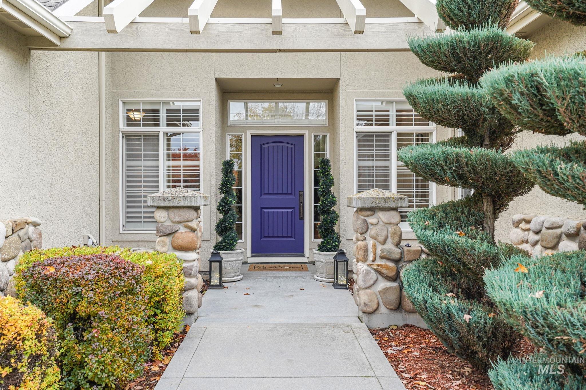 View of exterior entry with stucco siding