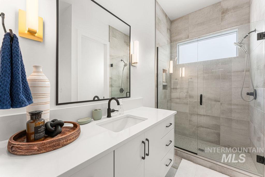 Contemporary bathroom featuring a single vanity with a white countertop and rectangular undermount sink