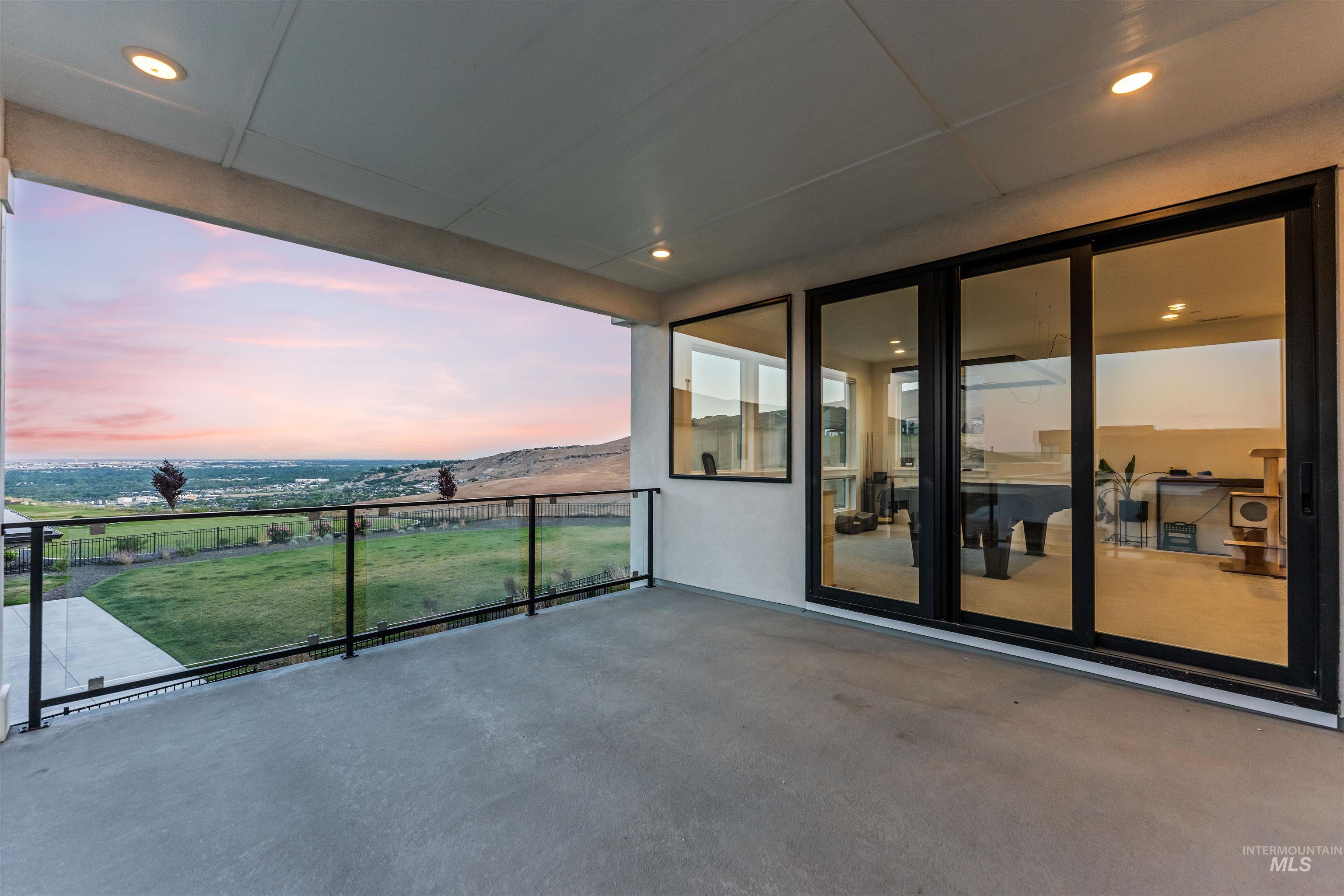 Spacious outdoor concrete patio featuring recessed lighting